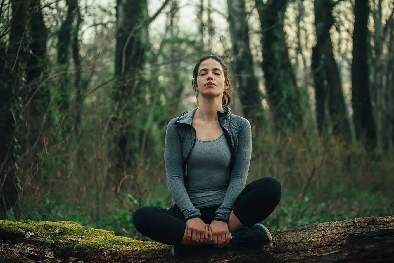 Person practicing mindfulness in a peaceful green space